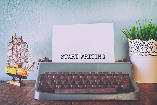 Typewriter with "Start Writing" typed on paper