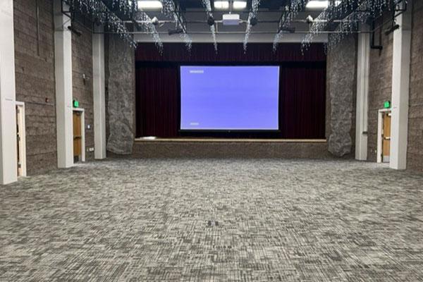The event hall showing a screen on stage.